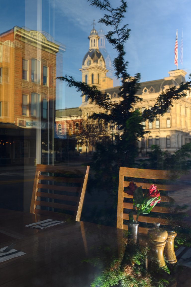 A reflection of the Wayne County Courthouse in the window of Broken Rocks Cafe and Bakery in Wooster, OH.